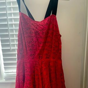 Pink and black lace dress with straps and exposed zipper that hits above knee